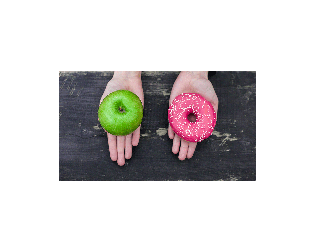 Hands showing choice between an apple or donut