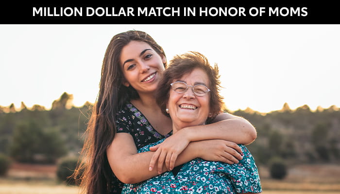 Mother and Daughter hugging and smiling for camera
