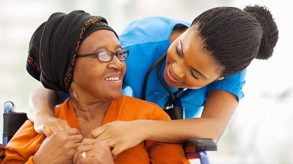 Patient and nurse smiling and embracing