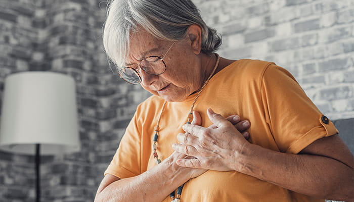 Woman clenching at chest