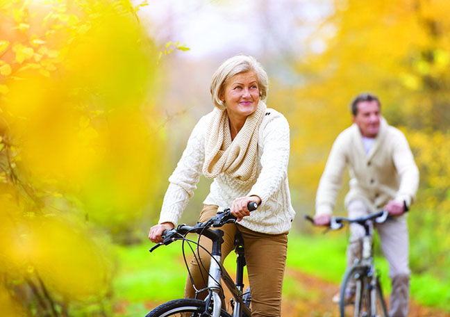 Older Couple Biking Fall