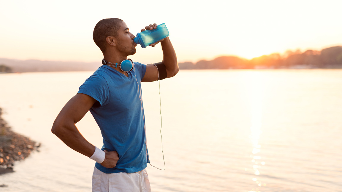 man drinking during workout