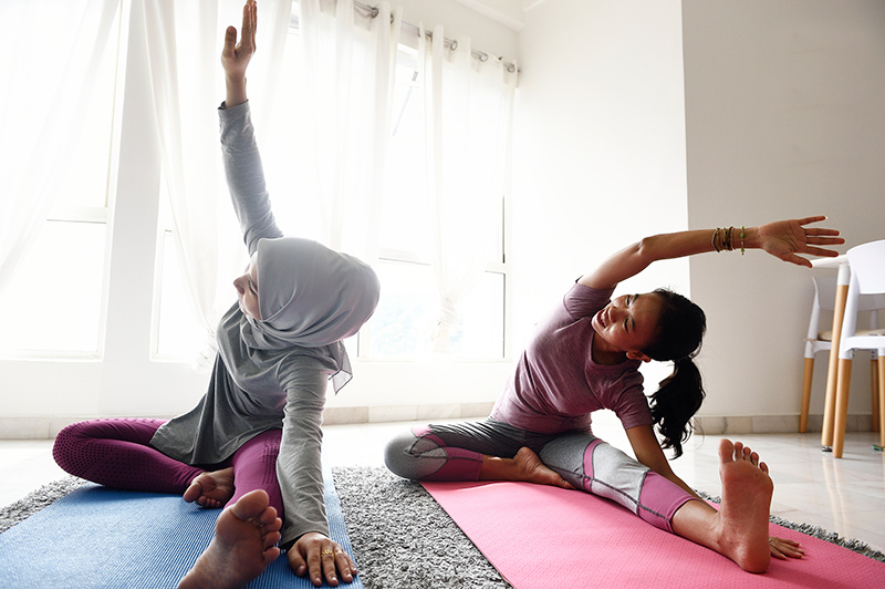 mother daughter do yoga at home