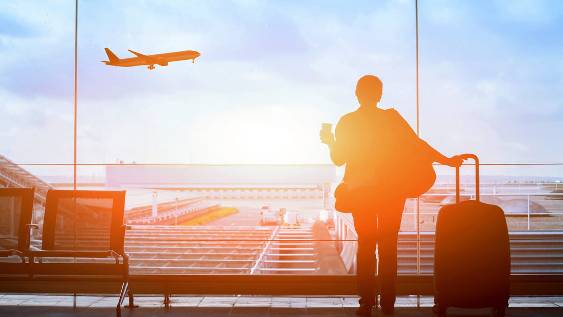 silhouetted woman traveler waiting for airplane to land