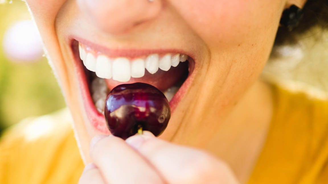 woman eating cherry