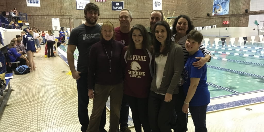 Ashley Dumais (front middle) with some of the “dream team” members who helped save her. Clockwise from top left: UNH graduate swim coach Dan Duvall, Jr., anesthesiologist Mike Lane, Ashley’s dad Randy, ICU nurse Laura Zercher, physician Patty Hodge, Ashley’s mom Bonnie, Ashley and EMT Sarah Carrico.