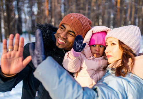 family in snow at sunset family in snow at sunset