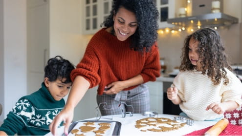 Woman with two kids making cookies