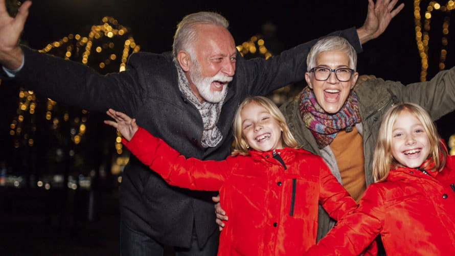 Two adults and two children in red celebrating