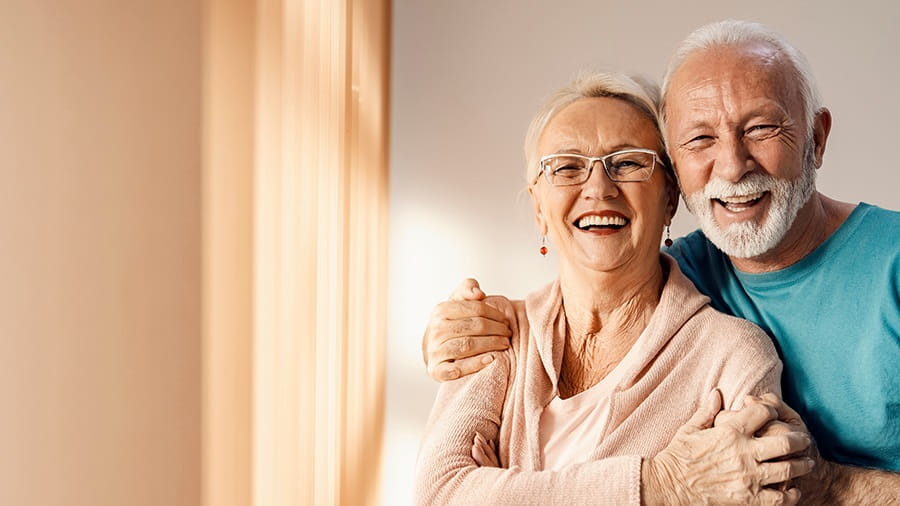 Two people smiling into the camera