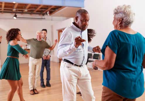 diverse group of people dancing in a dance class