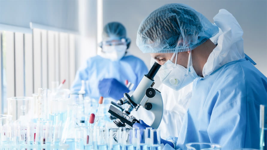 Researcher looking through microscope