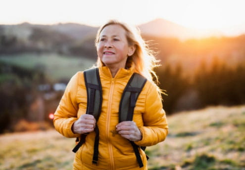 woman backpacking at sunset woman backpacking at sunset