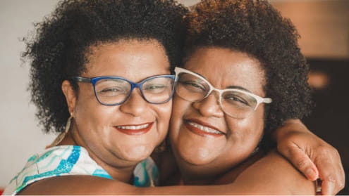 Two women hugging and smiling