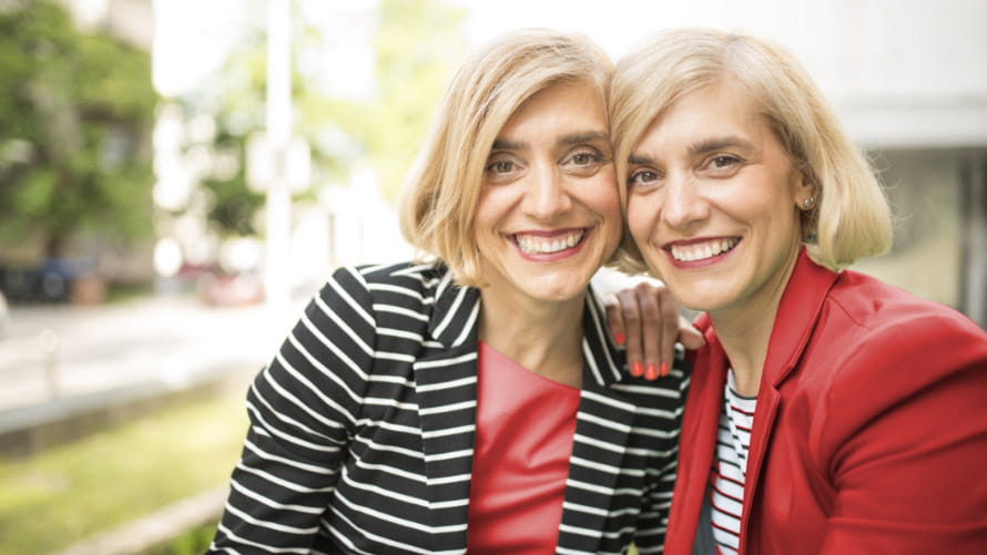 Twin sisters smiling