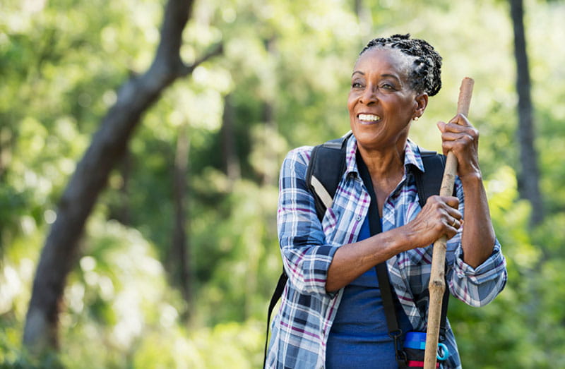 smiling senior woman hiking smiling senior woman hiking