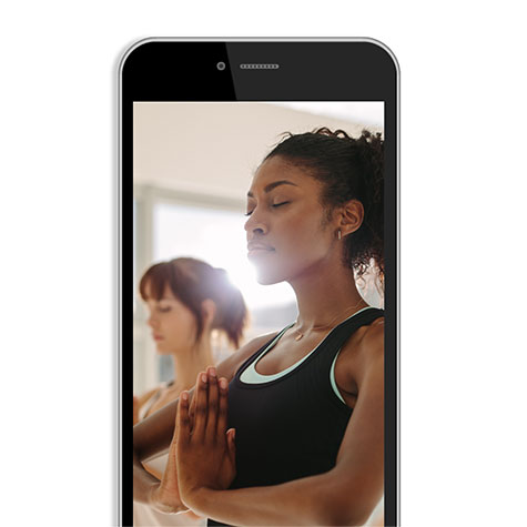 woman meditating on cell phone screen woman meditating on cell phone screen