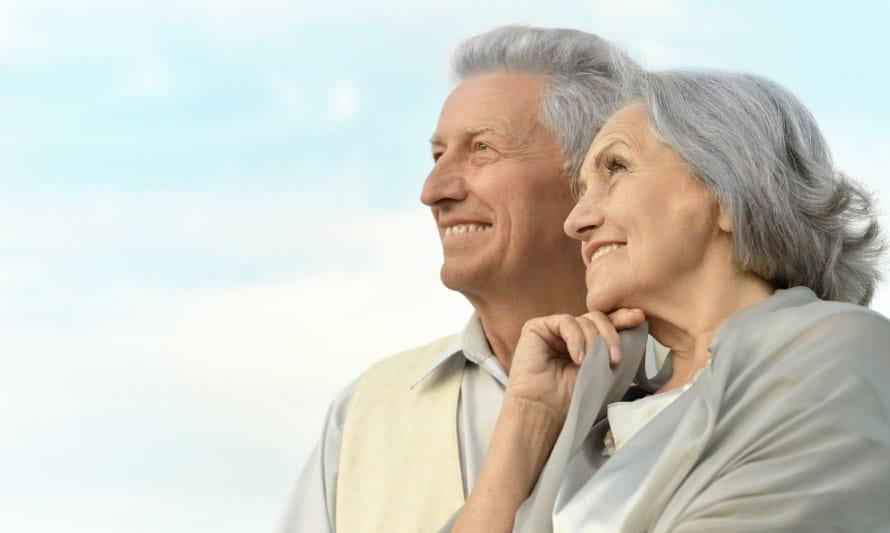 senior couple smiles looking into distance senior couple smiles looking into distance