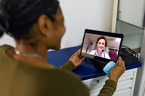Woman talking to a medical professional on a tablet