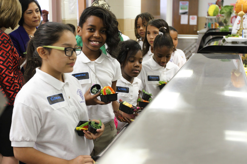 Children Wait in a School Lunch Line