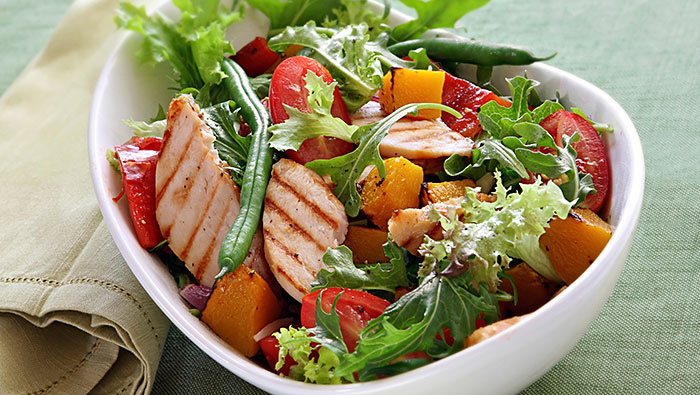 salad bowl of grilled chicken and peaches