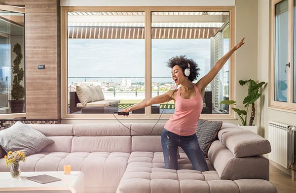 woman wearing headphones dancing at home woman wearing headphones dancing at home