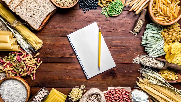 Wholegrain and dietary fiber food border with notebook.