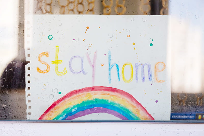 stay home crayon rainbow in window