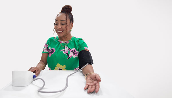 woman measures her blood pressure