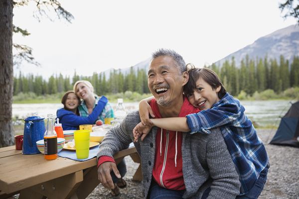 Family with children enjoying a picnic in the mountains