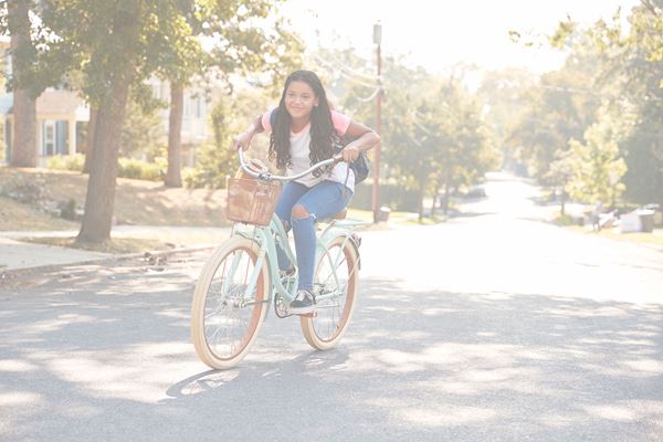 Young girl riding a bike in the street
