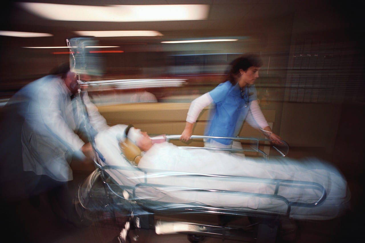 blurred image of a hospital staff rushing a patient through a hospital