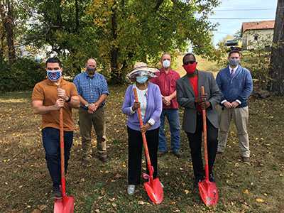 several people posing with shovels
