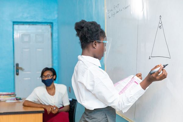 student writing on whiteboard