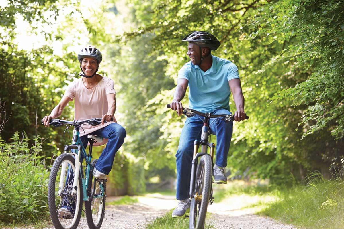 couple riding bikes on a trail