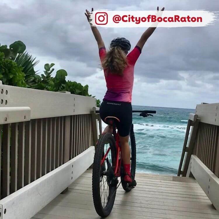 woman on bike path near beach