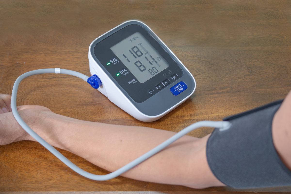 person's arm in a blood pressure cuff