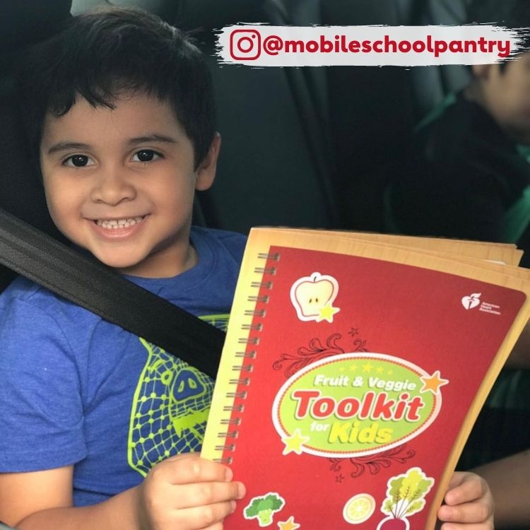 smiling boy holding notebook