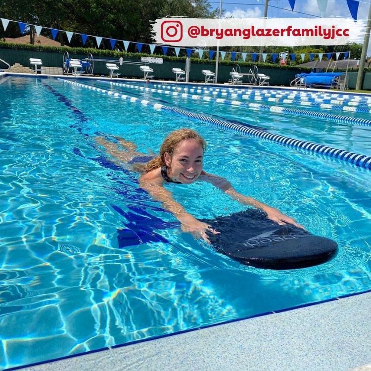 girl swimming with paddle board in pool