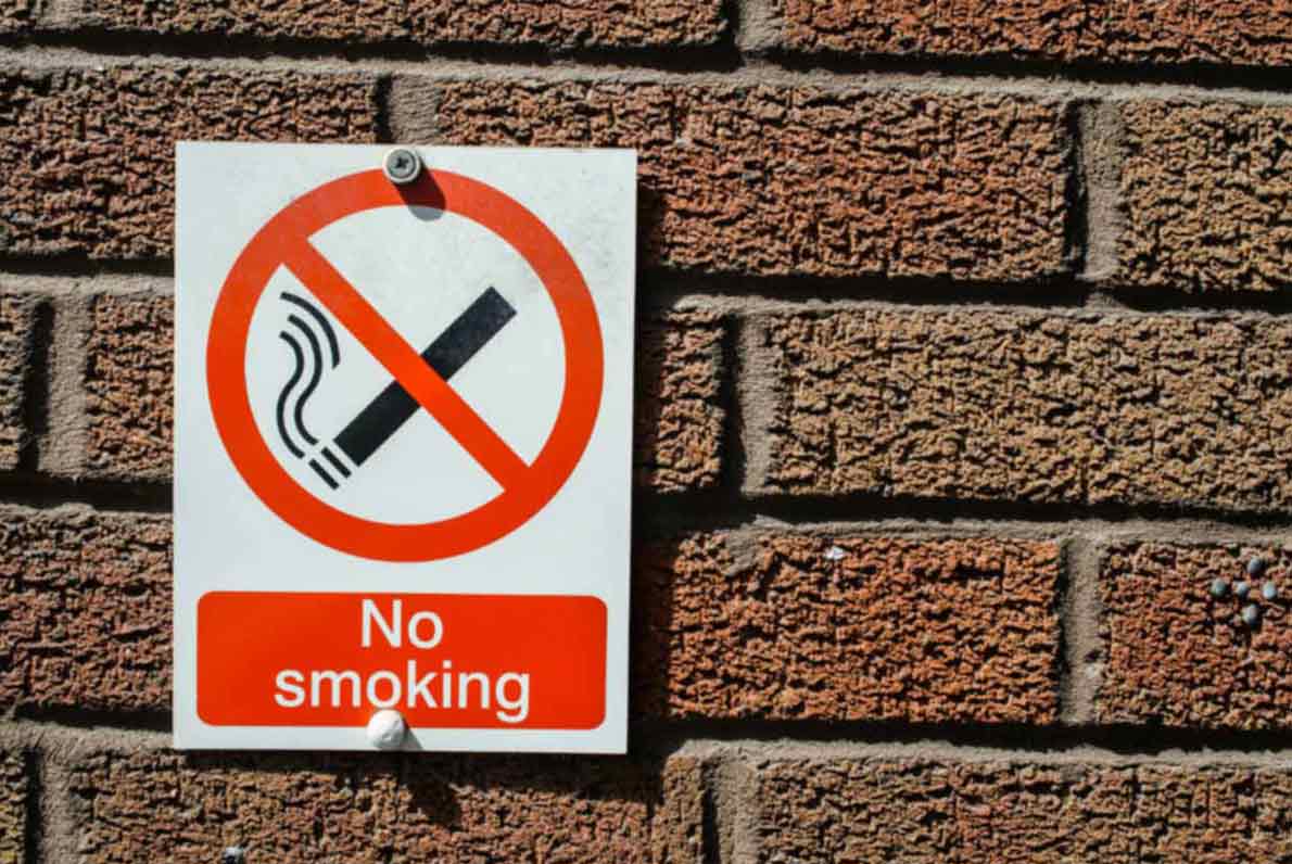 No Smoking sign on brick wall