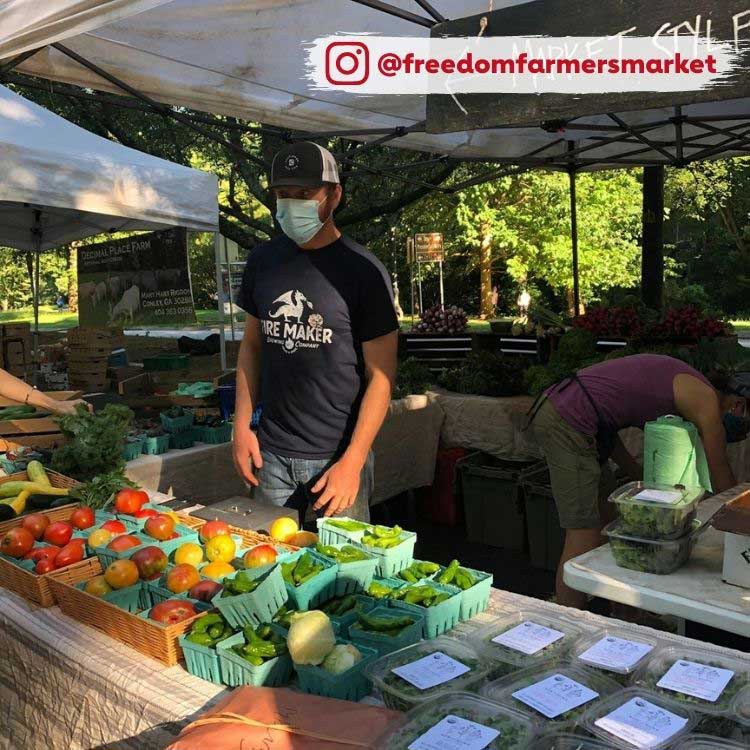 man in mask at farmer's market