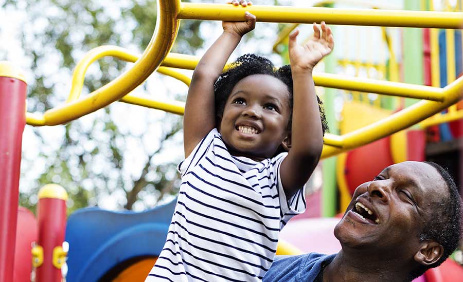 young girl with dad at playground
