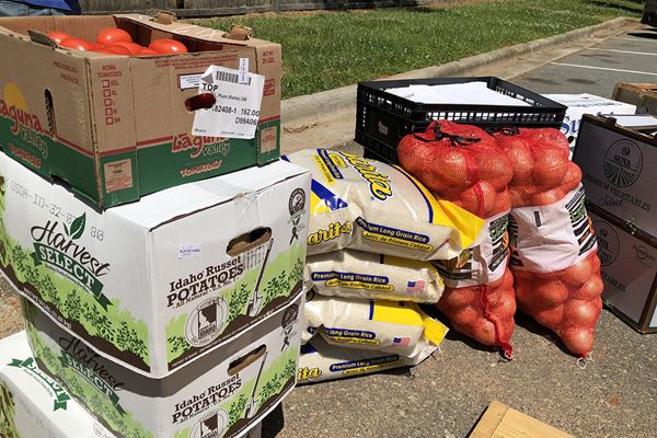 Boxes of produce stacked on the pavement