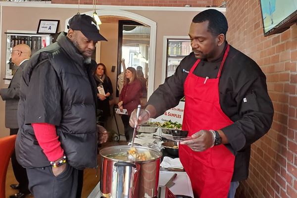 Chef N'Gai serving food