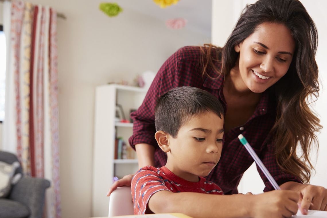 mom watching son do homework