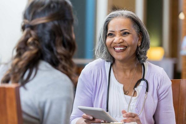 medical care worker consulting with woman