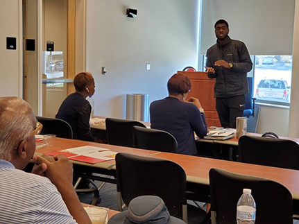 man presenting to group meeting