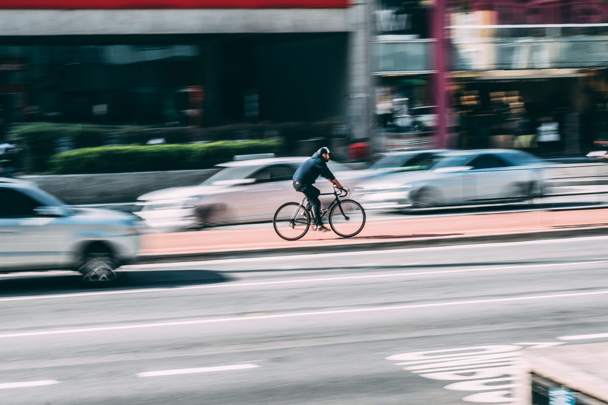 bicyclist riding through traffic