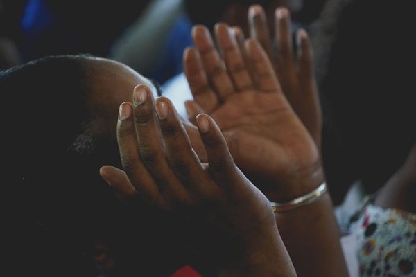 churchgoer raising their hands up