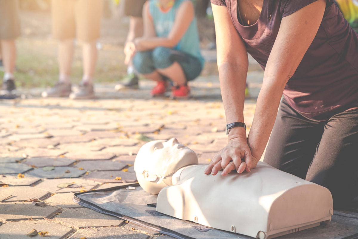 person practicing hands only CPR on a dummy